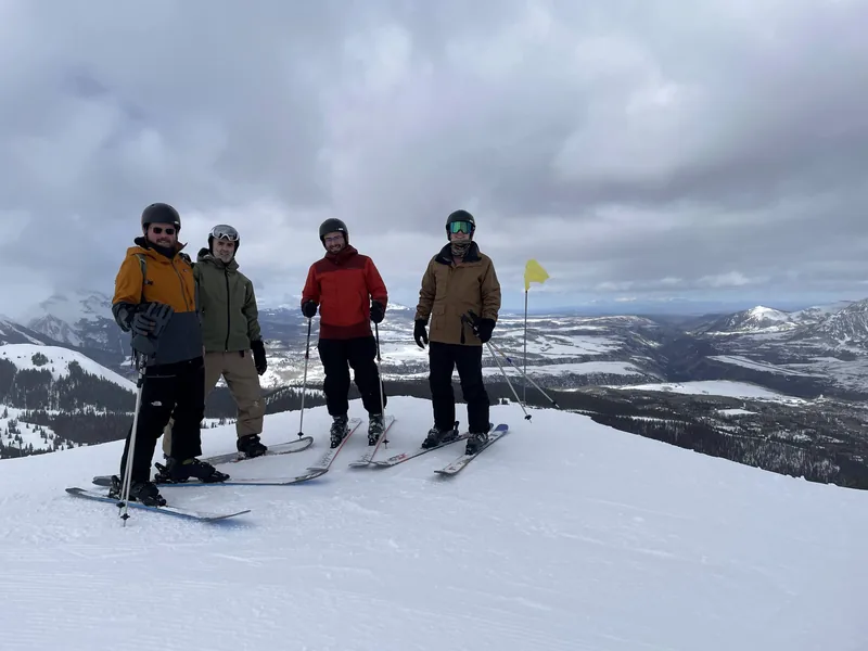 OurHive team skiing trip at a mountain summit